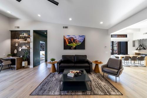 a living room with two chairs and a table at LaFave Luxury Rentals at Zion in Springdale