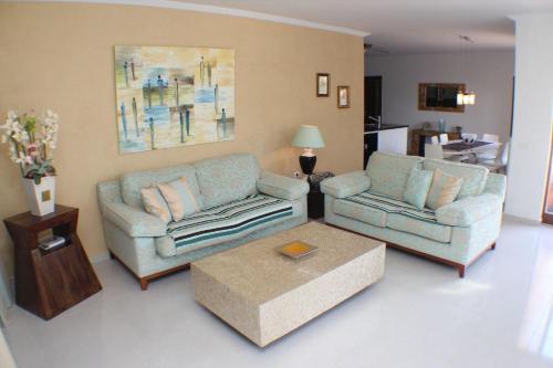 a living room with two couches and a coffee table at Ferienhaus mit hellem Wohnbereich, zwei Schlafzimmern und einer Terrasse in Guía de Isora