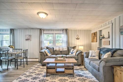 a living room with a couch and a table at Buttermilk Cottage in Cape Cod Steps to Beach in Wareham