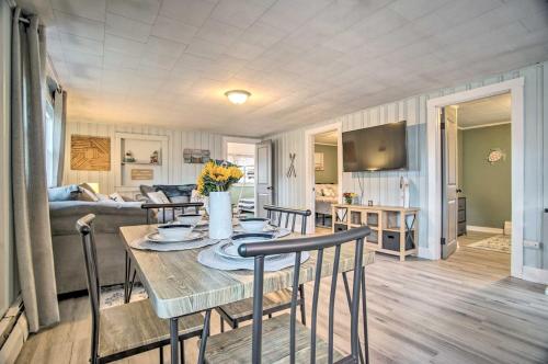 a dining room and living room with a table and chairs at Buttermilk Cottage in Cape Cod Steps to Beach in Wareham