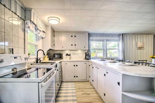 a kitchen with white cabinets and white appliances at Buttermilk Cottage in Cape Cod Steps to Beach in Wareham