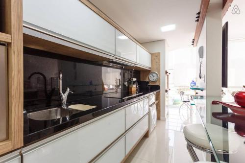 a kitchen with a sink and a counter top at Apartamento JURERE in Florianópolis