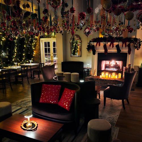 a living room with a fireplace and christmas decorations at The Shore Club in Spring Lake Heights