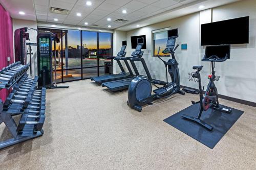 a gym with tread machines and a flat screen tv at Home2 Suites By Hilton Weatherford in Weatherford