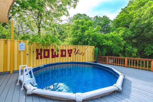 a swimming pool on a deck with a wooden fence at Pool, Gameroom & Minigolf Enchanting Texas Home in San Antonio