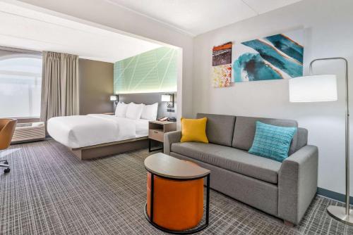 マディソンにあるComfort Inn & Suitesのベッドとソファ付きのホテルルーム
