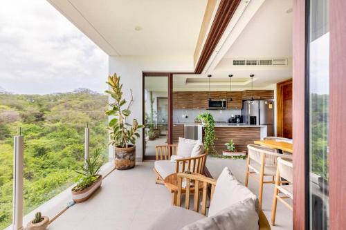 a kitchen and dining room with a table and chairs at Jungle by Pardela, La Cruz de Huanacaxtle in Cruz de Huanacaxtle