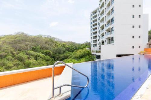 a swimming pool on the balcony of a building at Jungle by Pardela, La Cruz de Huanacaxtle in Cruz de Huanacaxtle