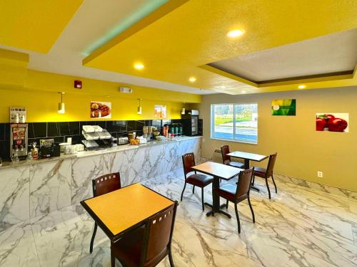 a dining room with two tables and a counter at Quality Inn & Suites Willows in Willows