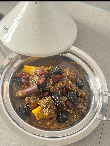 a bowl of food with blackberries and other foods at ChezBabo Wellness Hotel in Ngaparou