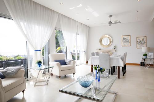 a living room with a table and chairs at J&B Place in Ponta Delgada
