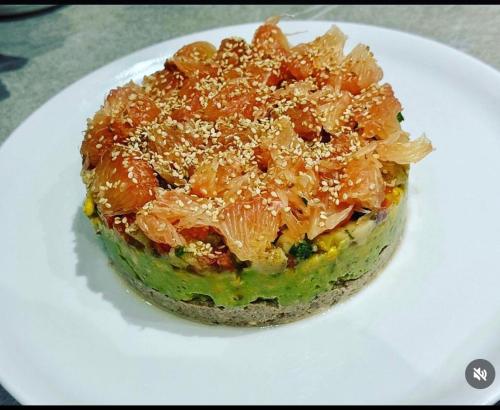 a piece of food sitting on a white plate at ChezBabo Wellness Hotel in Ngaparou