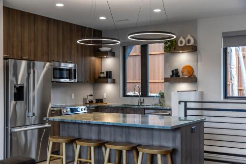 a kitchen with a counter with stools in it at LaFave Luxury Rentals at Zion in Springdale