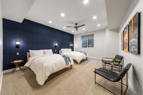 a bedroom with two beds and a blue wall at LaFave Luxury Rentals at Zion in Springdale