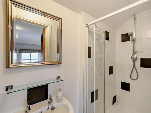 a bathroom with a sink and a mirror and a shower at 3 Bed in Allendale 92147 in Allendale Town