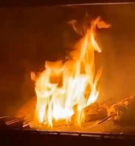 a fire is burning in a fireplace with flames at ChezBabo Wellness Hotel in Ngaparou