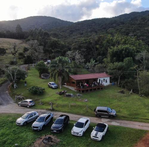 a group of cars parked in front of a house at Fazenda Serramar in Palhoça