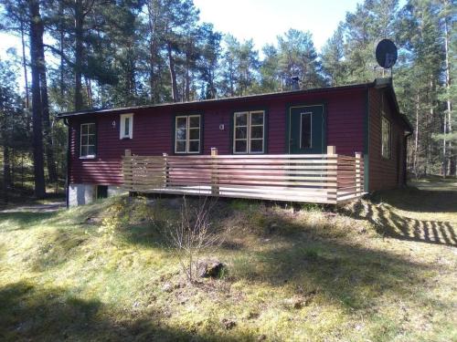 uma pequena casa vermelha na floresta em Ferienhaus in Yngsjö wenige Schritte zum Meer em Yngsjö