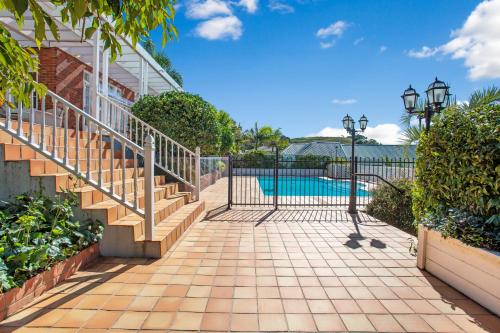 a gate with stairs leading to a swimming pool at Grande Vista 5Br Manor with Pool & Mt Eden Views in Auckland