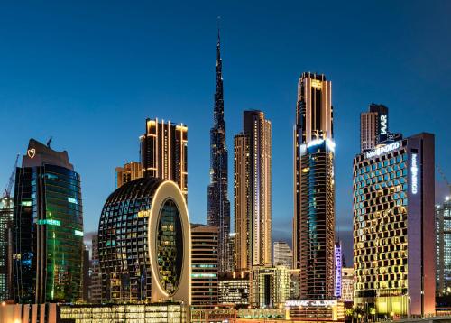 a skyline of a city with tall buildings at Shared Private Room in Downtown Business Bay in Dubai
