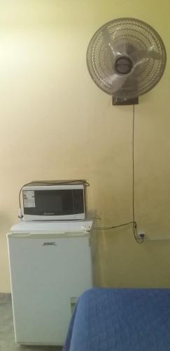 a fan sitting on top of a refrigerator next to a bed at Alojamiento en La Rioja + SERVICIO TURISTICO in La Rioja