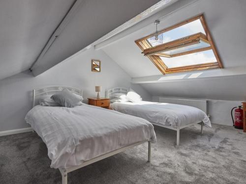 a attic bedroom with two beds and a skylight at 3 Bed in Wasdale SZ205 in Santon Bridge