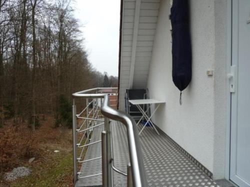 un porche con dos taburetes en el lateral de una casa en Ferienwohnung auf zwei Etagen, inmitten herrlicher Landschaft - b48738, en Pretzfeld