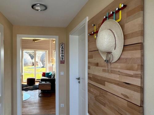 a room with a wooden wall with a fan and a door at Nordkugel - Kugelhaus am See in Penzlin