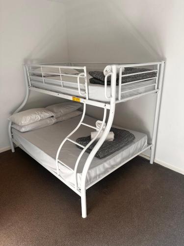 a white bunk bed with a white shelf at Bundalong Villas in Bundalong