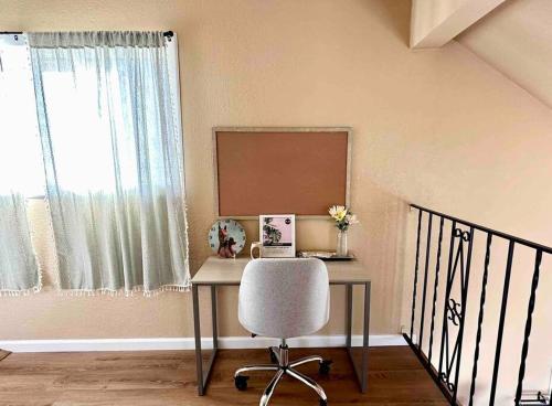 a desk with a chair in a room with a window at Cozy Cabin in the City plus GYM in Winnemucca
