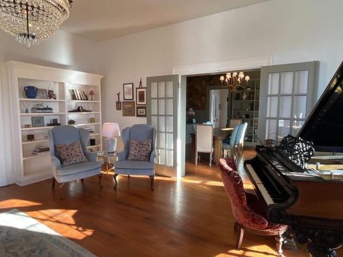 路易維爾的住宿－Tranquil Terrace Retreat in Frankfort，客厅配有钢琴和椅子