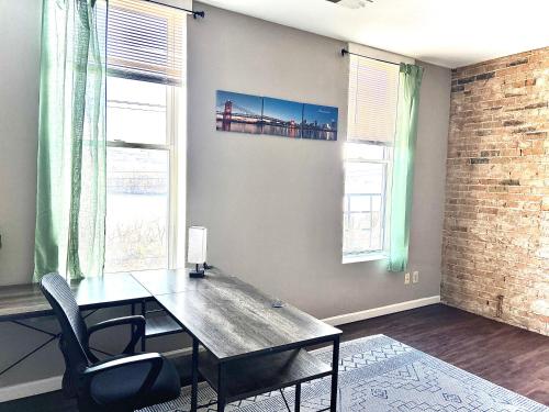 a dining room with a table and chairs and windows at Spacious 3 bedroom Overlooking River in Cincinnati