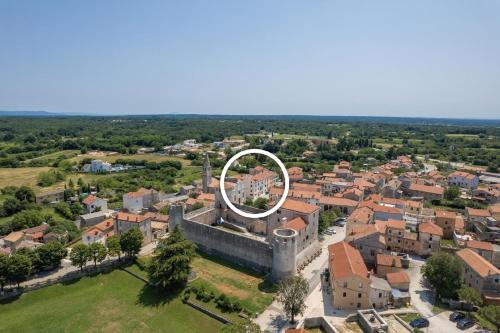 an aerial view of a city with a white circle on top of a building at Charmantes Ferienhaus in Svetvinčenat mit Privatem Pool in Svetvinčenat