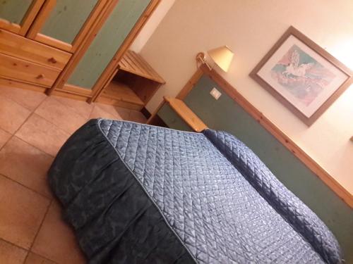 a bedroom with a bed with a blue blanket at Locanda Del Re sole in Ferrara