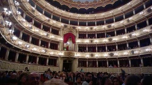a group of people standing in a large auditorium at Appartamenti I Liutai in Cremona
