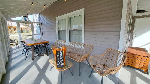 a porch with a table and chairs on a house at Harbert's Gem in Harbert