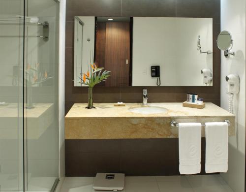 a bathroom with a sink and a toilet and a shower at Hotel Estelar Milla De Oro in Medellín