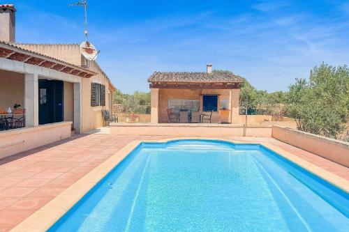 a swimming pool in front of a house at Ferienhaus mit Privatpool für 6 Personen ca 120 qm in Campos, Mallorca Südküste von Mallorca in Campos