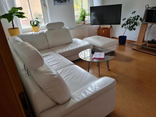 a living room with a white couch and a table at Appartement in WeißwasserOberlausitz mit Großem Garten in Weißwasser
