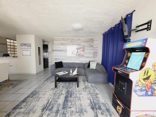 a living room with a couch and a video game at Cozy Corner w/private pool in Vega Baja