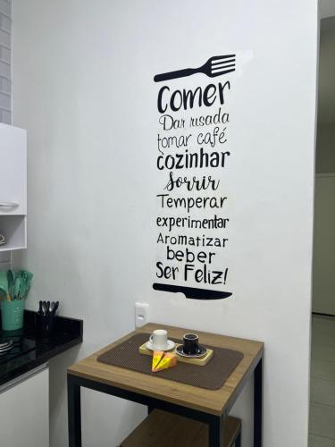 a table in a kitchen with a sign on the wall at Flamengo Home in Rio de Janeiro