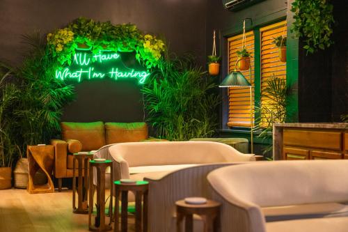 a restaurant with a neon sign that says wait haaretz at The 1888 Hotel in St Petersburg