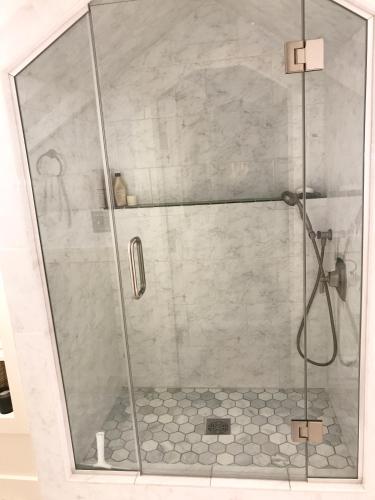 a shower with a glass door in a bathroom at Beautiful Luxury Suite A & B of Shorewood Home in Shorewood