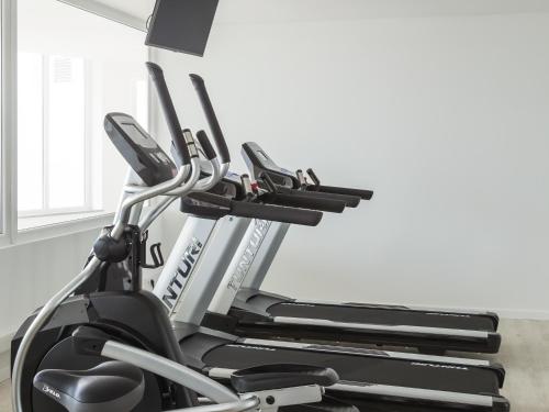 an exercise bike in a room with a window at MH Peniche in Peniche