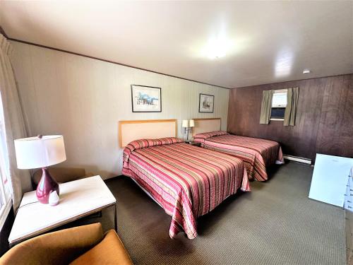 a hotel room with two beds and a lamp at Red Top Motor Inn in Iron Bridge