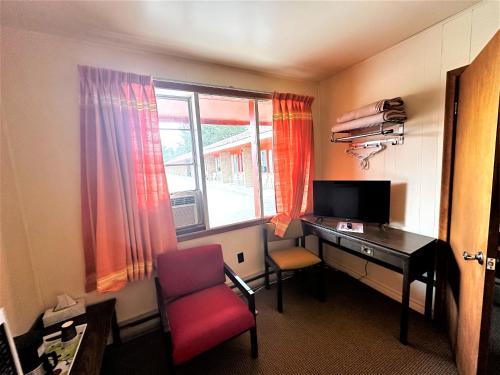 a room with a desk and a chair and a window at Red Top Motor Inn in Iron Bridge