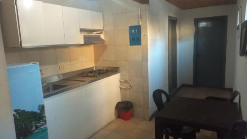 a small kitchen with a stove and a table at HOTEL VISTA AL MAR habitacion para 6 personas in Rodadero