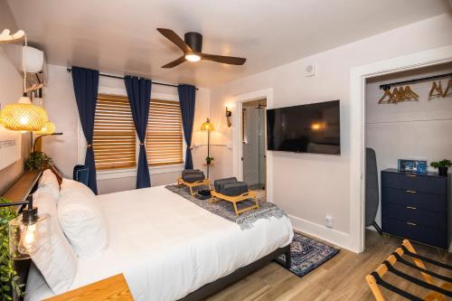 a bedroom with a large bed with a ceiling fan at The 1888 Hotel in St Petersburg
