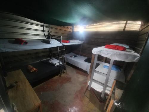 an overhead view of a room with two bunk beds at coraizone hostel in Cobán