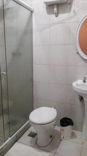 a bathroom with a shower and a toilet and a sink at Varzea Palace Hotel in Teresópolis